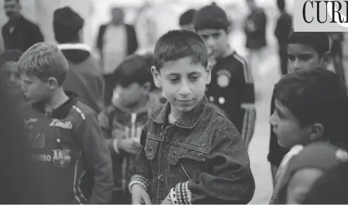  ?? PHOTOS: MAYA ALLERUZZO / THE ASSOCIATED PRESS ?? Akram Rasho Khalaf, 10, is pictured with other children on Friday at the Kabarto Camp for internally displaced people in Dahuk, Iraq. Akram was captured, trained and sold into servitude by ISIL militants when he was seven. He suffers from nightmares...