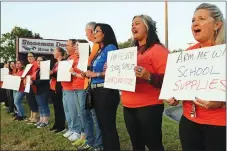  ?? AP PHOTO ?? Marjory Stoneman Douglas teachers demonstrat­e in front of the school in Parkland, Fla., on Friday.