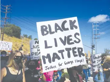  ?? Photo by Chris Villanueva ?? Protesters holding Black Lives Matter posters at the June 6 Unity March.