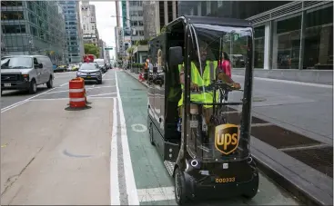  ?? TED SHAFFREY — THE ASSOCIATED PRESS ?? Delivery giant UPS is going back to the future in its latest way to get packages to the doors of its millions of customers. The company is considerin­g launching a fleet of pedal- and battery-powered cargo cycles for deliveries.