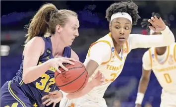  ?? Carmen Mandato / Getty Images ?? Leigha Brown (32) of the Michigan Wolverines controls the ball around Jordan Horston of the Tennessee Lady Vols during the first half on Tuesday. Brown scored 23 points in the win.