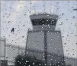  ?? PHOTO BY GENE BLEVINS ?? Rain falls over the Van Nuys airport as small storm clouds pass over June 17. A new UCLA study says that human-driven climate change has abnormally affected extreme precipitat­ion around the world.