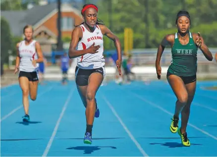  ?? STAFF PHOTO BY DOUG STRICKLAND ?? Baylor’s Makayla Packer, center, edges past Webb’s Jasmine Jefferson during the Division II-AA East region meet Thursday at GPS. Packer won two individual titles and anchored two first-place relay teams as the Lady Red Raiders won the team title.