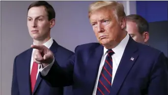  ?? ALEX BRANDON- THE ASSOCIATED PRESS ?? President Donald Trump points to a reporter to ask a question as he speaks about the coronaviru­s in the James Brady Press Briefing Room of the White House, Thursday, April 2, in Washington, as White House adviser Jared Kushner listens.