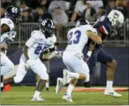  ?? STEPHEN DUNN - THE ASSOCIATED PRESS ?? UConn running back Nate Hopkins, right, scores in the second quarter of an NCAA game against Holy Cross, Thursday in East Hartford.