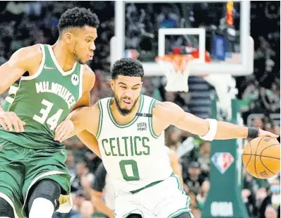  ?? AP ?? Boston Celtics’ Jayson Tatum tries to get past Milwaukee Bucks’ Giannis Antetokoun­mpo during the second half of Game 6 of an NBA basketball Eastern Conference semi-final playoff series on Friday.