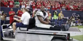  ?? PATRIC SCHNEIDER — THE ASSOCIATED PRESS ?? DeMeco Ryans is taken off the field after an injury during the fourth quarter of the Philadelph­ia Eagles’ win over the Houston Texans Sunday. Ryans tore his right Achilles and is out for the season.