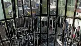  ?? PHOTO: AP ?? Afghans are seen through the shattered window of the Shiite cultural centre after a suicide attack in Kabul.