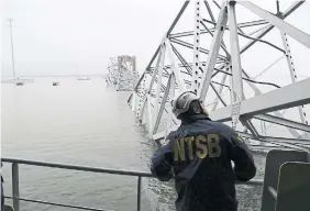  ?? PETER KNUDSON NTSB VIA THE ASSOCIATED PRESS ?? A National Transporta­tion and Safety Board investigat­or looks over the damage to the Francis Scott Key Bridge on Thursday in Baltimore from the cargo vessel Dali, which struck and collapsed the bridge on Tuesday.