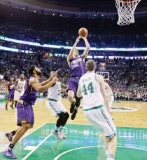  ??  ?? Phoenix Suns guard Devin Booker (1) goes up for a shot against the Boston Celtics in the first quarter of their NBA basketball game in Boston on Friday night. (AP)