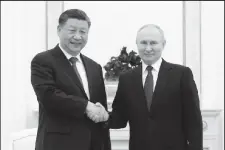  ?? ?? Russian President Vladimir Putin (right) shakes hands with Chinese President Xi Jinping during a meeting at the Kremlin in Moscow, Russia, March 20, 2023. Sputnik/Sergei Karpukhin/Pool via REUTER