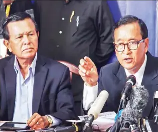  ?? POST STAFF ?? The Cambodia National Rescue Party’s Sam Rainsy (right) and Kem Sokha speak at a press conference in Phnom Penh in 2013.