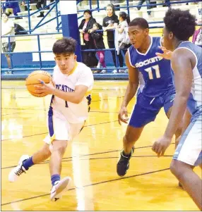  ?? Westside Eagle Observer/MIKE ECKELS ?? Christian Ramirez (Decatur 1) drives past the free-throw line into a crowd of Rocket defenders on his way to the basket during the third quarter of the Decatur-Future School of Fort Smith varsity basketball game at Peterson Gym on Thursday.