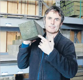  ??  ?? Don’t burn: Councillor Matt Lawrey with treated timber which should not be burnt because it produces arsenic.