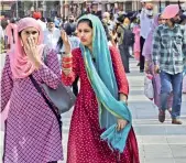  ?? PTI ?? People not adhering to Covid-19 norms walk at Heritage Street near Golden Temple in Amritsar on Tuesday. Punjab, which has the highest case fatality rate of 2.4 per cent in the country, registered more than 100 deaths due to Covid-19 every single day in May. —