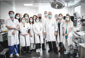  ??  ?? Head of the Department of Obstetrics and Gynaecolog­y and Reproducti­ve Medicine at the Foch Hospital Jean-Marc Ayoubi poses with his team in Suresnes, west of Paris, yesterday.