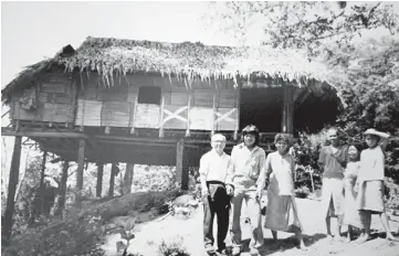  ??  ?? Lim is seen with a family during one of his many visits to rural areas.