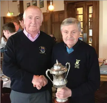  ??  ?? President of Wicklow Golf Club, Mosey Coffey presents the Garden Trophy to the Coollattin Golf Club President, Tony Ryan.