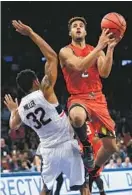  ?? FRANK FRANKLIN II/ASSOCIATED PRESS ?? Melo Trimble drives past Connecticu­t’s Shonn Miller. The Maryland point guard made 14 of 15 free throws to help the Terps stave off the Huskies’ comeback in the second half.