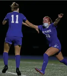  ?? MaTT sToNe / heraLd sTaFF ?? OPEN ARMS: Elizabeth Finn (20) and Leiney Smith (11) celebrate during Scituate’s win yesterday.