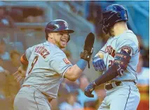  ?? JOHN MINCHILLO/ASSOCIATED PRESS ?? Houston Astros catcher Christian Vazquez (9) congratula­tes Chas McCormick (20) after McCormick hit a two-run home run against the New York Yankees during the second inning Saturday in New York.