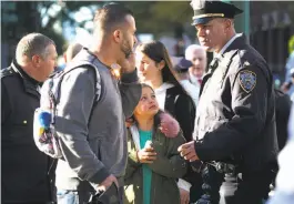  ?? Todd Heisler / New York Times ?? A police officer talks to bystanders after a truck driver ran down people, killing eight and injuring 11 before police shot and critically wounded him.