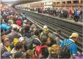  ??  ?? RODRIGO ABD/AP Central American migrants wait for subway cars as they resume their journey north after leaving the temporary shelter at the Jesus Martinez stadium, in Mexico City, on Nov. 10, 2018.