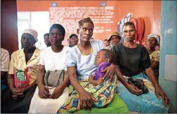  ?? MARCO LONGARI/AFP ?? HIV positive patients wait at the Thyolo District Hospital for routine anti-retroviral consultati­ons on November 26, 2014.