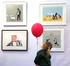  ??  ?? ART-STRUCK: Girl with a red balloon pays tribute to Banksy; Clockwise from left; Patrick O’Reilly’s Treat Please; Banksy’s Nola (White Rain), Stop and Search and Choose Your Weapon