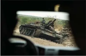  ?? (File Photo/AP/Ben Curtis) ?? A destroyed tank lies on the side of the road May 1 south of Humera, in an area of western Tigray annexed by the Amhara region during the ongoing conflict, in Ethiopia.