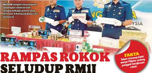  ?? V ?? MADRIM (tengah) menunjukka­n sebahagian rokok keretek seludup pelbagai jenama yang dirampas di Kampung Bubul Laut Semporna.
lelaki Tahan seorang
sedang warga Filipina
bungkusan punggah
rokok