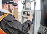  ??  ?? Fuel Specialist Justin Eubanks replaces an inspection sticker on a dispenser at a fuel retailer’s location in southwest Oklahoma City. When motorists see the sticker, they know the dispenser has been checked to be sure it accurately delivers the...