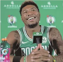  ?? STAFF PHOTO BY MATT STONE ?? BETTER DAYS AHEAD: Celtics guard Marcus Smart, who lost his mother to cancer during the summer, laughs while talking to reporters yesterday in Canton.