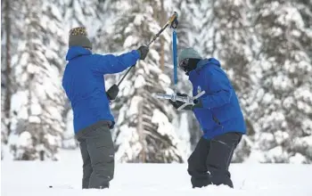  ?? RANDALL BENTON AP FILE ?? Department of Water Resources employees check the depth of the snowpack near Echo Summit on Dec. 30.