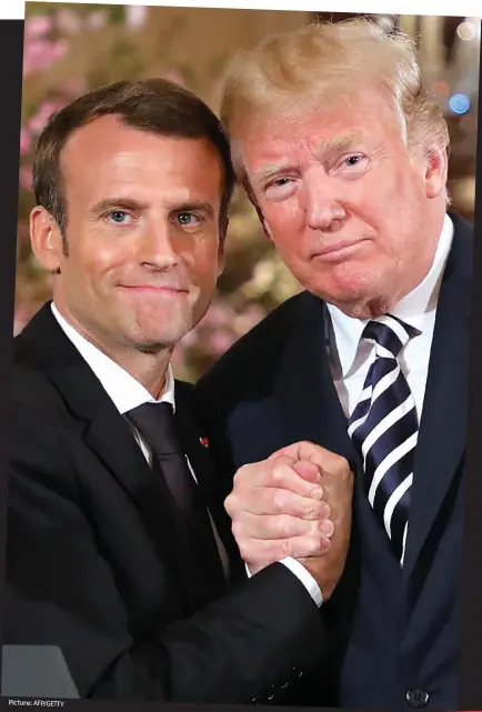  ??  ?? Le bromance: Presidents Emmanuel Macron and Donald Trump lock arms during the French leader’s state visit to Washington DC this week Picture: AFP/GETTY