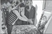  ?? HT PHOTO ?? Congress state president Ganesh Godiyal offers tribute to Gen Bipin Rawat at his ancestral Sain village on Tuesday.