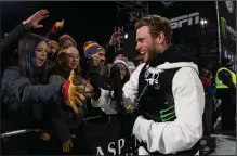  ?? (AP/The Aspen Times/Kelsey Brunner) ?? Gus Kenworthy (right) greets friends and fans at the base of the superpipe at the Winter X Games in Aspen, Colo., last month. Kenworthy is among the few Olympians who were willing to speak out about China’s troubling human rights record leading up to the Olympics.