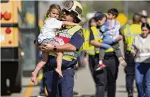  ?? AUSTIN AMERICANST­ATESMAN / AP ?? Children are transporte­d from a fatal school bus crash on Friday in Bastrop, Texas. Authoritie­s say a school bus collided with a concrete truck, killing a boy on the bus and a man in another vehicle.