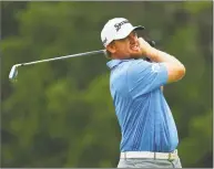  ?? Tim Bradbury / Getty Images ?? J.B. Holmes plays his shot from the fifth tee during the third round of the Travelers Championsh­ip at TPC River Highlands on Saturday in Cromwell.