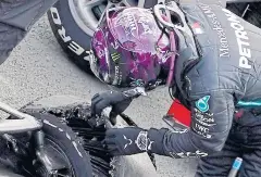  ?? AFP ?? Lewis Hamilton inspects his punctured tyre after winning the British Grand Prix.