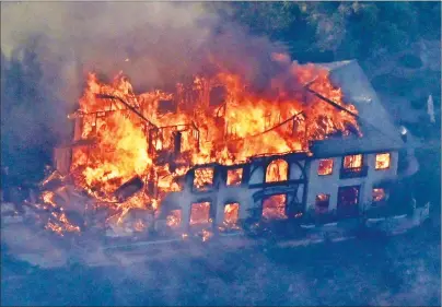  ?? AP PHOTO ?? A home burns Friday, Nov. 9, 2018, as seen from a helicopter in the Calabasas section of Los Angeles.