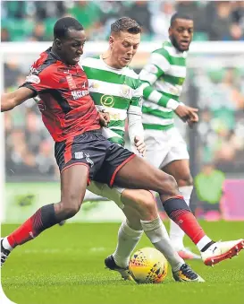  ??  ?? Celtic’s Callum McGregor tries to dispossess Glen Kamara
