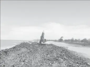  ??  ?? An excavator sealing the remainder of the breach between Dantzig and Fairfield