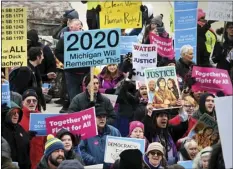  ?? DALE G.YOUNG/DETROIT NEWS VIA AP ?? Demonstrat­ors gather at the steps of the Capitol before going inside to chant in the Rotunda as the Michigan Senate and House of Representa­tives consider bills during a “lame duck” session in Lansing, Mich., on Wednesday.