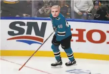  ?? Jeff Roberson / Associated Press ?? The Sharks’ Tomas Hertl dons a Justin Bieber mask to face Blues goalie Jordan Binnington in the shootout challenge. The real Bieber and Binnington will go 1on1 in the near future.