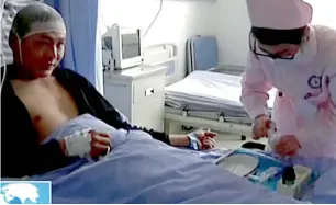  ?? AP Video ?? A nurse attends a survivor at a hospital after the landslide. —