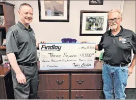  ?? Findlay ?? Tyler Corder, Findlay Automotive CFO, and Dan Johnson, Three Square senior developmen­t officer, hold a donation check for $11,500.