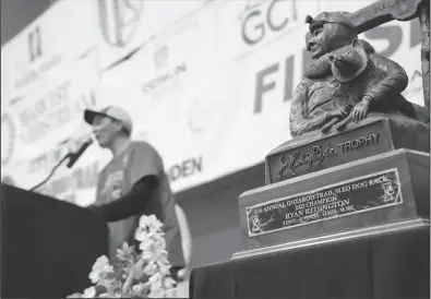  ?? Photo by Megan Gannon ?? THE TROPHY— Ryan Redington’s dream came true to bring home the Iditarod trophy that bears his grandfathe­r Joe Redington Sr.’s name.