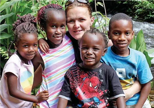  ??  ?? Remarkable bond: Claire Upshall pictured in Tanzania with her adopted children Isabella, left, Layla, Jack and Alfie