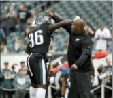  ?? MICHAEL PEREZ — THE ASSOCIATED PRESS ?? Philadelph­ia Eagles’ Jay Ajayi, left, and coach Duce Staley react during warm-ups before an NFL football game against the Denver Broncos, Sunday.